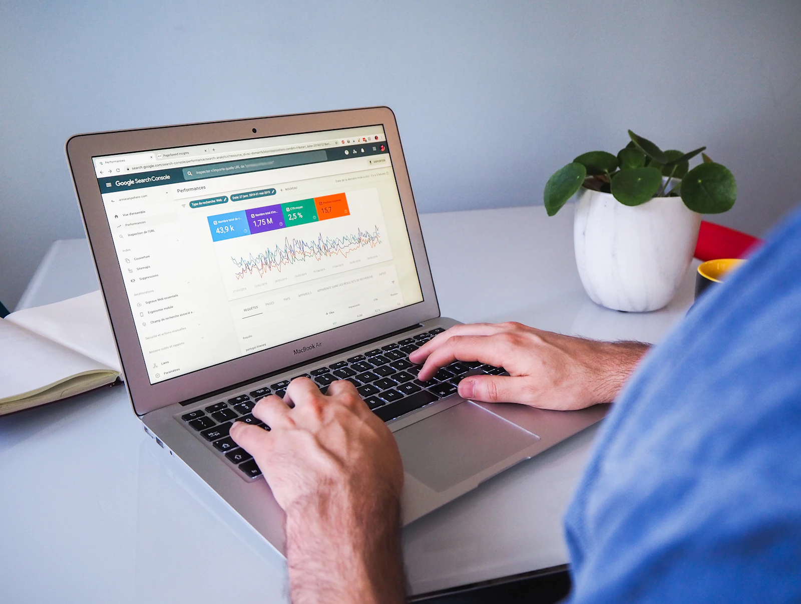 A marketer reviewing search data and query performance at a laptop