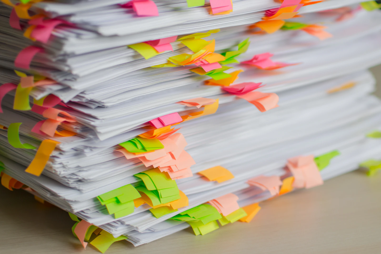 Stack of papers marked with colorful sticky tabs